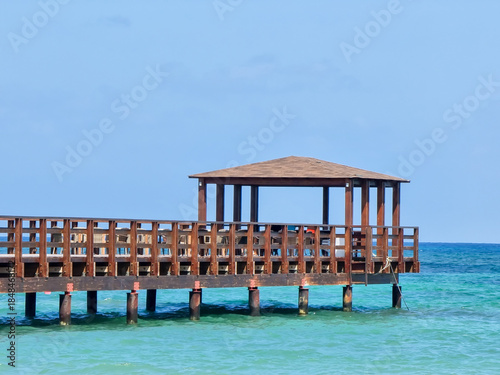 A pier stretching far out to sea.