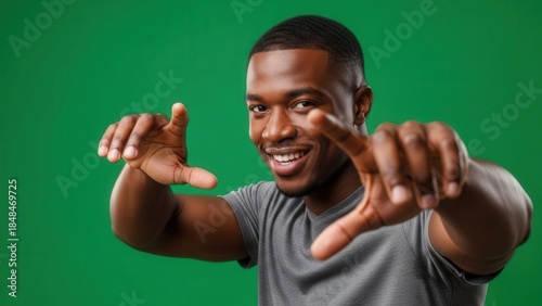 Portrait of a Smiling Young Man in Casual Gray T-Shirt Demonstrating Happiness and Confidence
