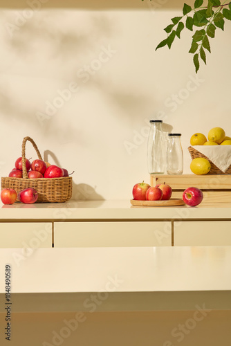 A small basket of apples and lemons with glass bottles decorated with countertop. Scene for advertising detox drinks, infusion recipes, or product and label placement