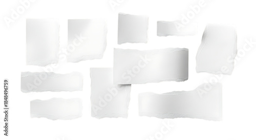 Collection of torn white paper scraps with rough edges isolated on dark surface