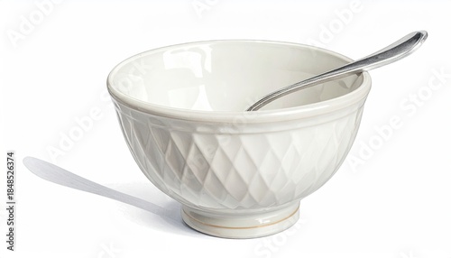 White empty bowl & spoon casting shadow on white surface, ready to be used indoors.