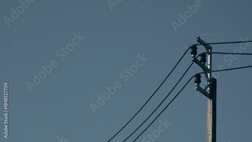 Power Pole with Electric Wires Against Clear Blue Sky During Bright Daylight Hours