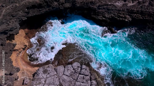 Waves crashing on Tenerife volcanic rocks, showcasing raw ocean energy