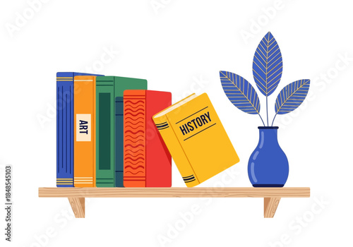 Collection of colorful books including art and history titles standing on a wooden shelf next to a blue vase with blue leaves
