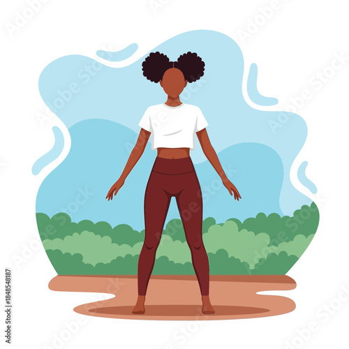 Fit young african american woman in sportswear standing with legs apart outdoors preparing for exercise or yoga session
