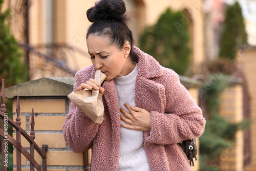 Mature woman with paper bag...