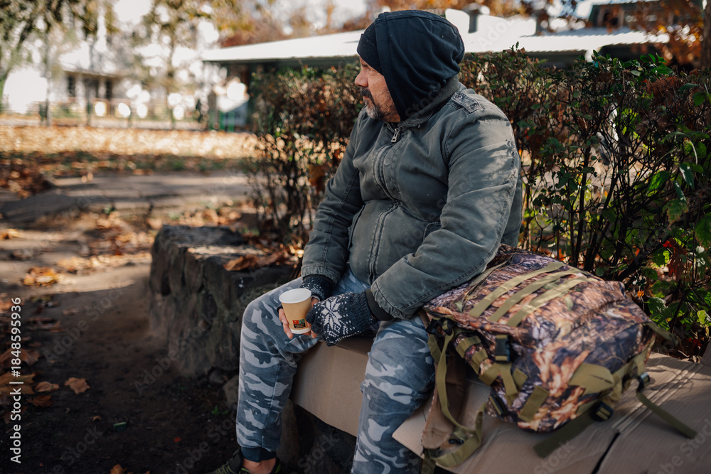 Fototapeta premium Homeless man experiencing poverty and social isolation in park