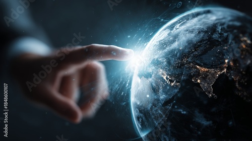 Fototapeta Naklejka Na Ścianę i Meble -  a hand pointing to a planet earth hologram against a dark background with digital elements