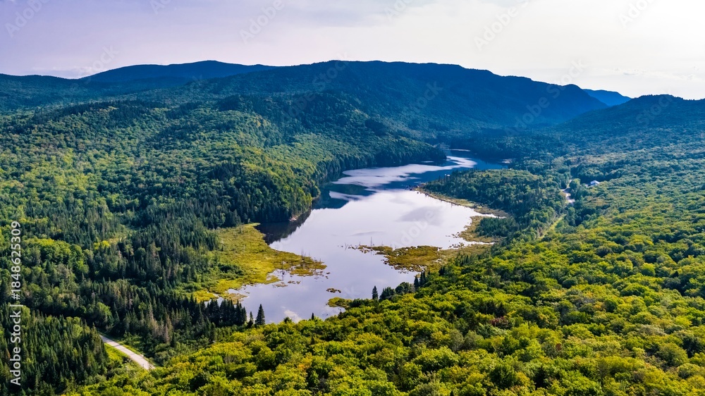 Fototapeta premium Aerial View from Mount Belanger, Quebec, Canada of Serpentine Lake in a Lush Mountain Forest
