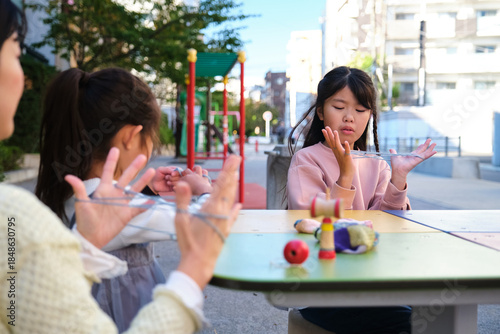Japanese girls playing cat's cradle string game
