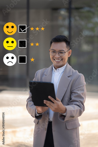 Business customer satisfaction survey photo. Happy businessman holding a digital tablet or rating Icons.