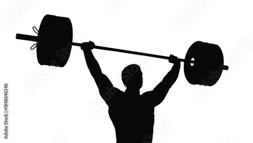 Silhouette of a muscular athlete successfully completing a heavy overhead barbell press in a high contrast gym setting