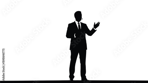 Silhouette of a professional businessman in a suit wearing a headset microphone gesturing while presenting on a stark white background stage