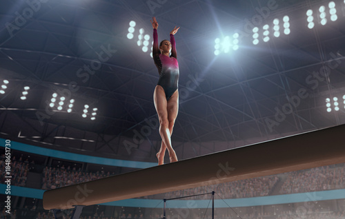 A gymnast performs a difficult trick on a balance beam.