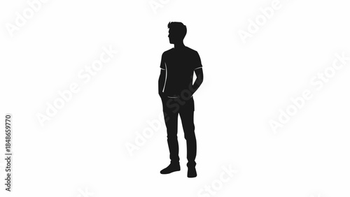 Silhouette of a young man standing with hands in pockets looking to the side.