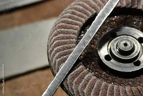 Fotografi Close up view of abrasive flap disc metal hub and grinding wheel surface during metalworking process on industrial workshop top view background