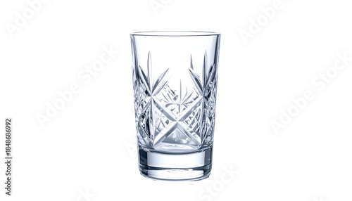 A close-up shot of a decorative, empty drinking glass with intricate cut crystal patterns. The glass sits on a black background