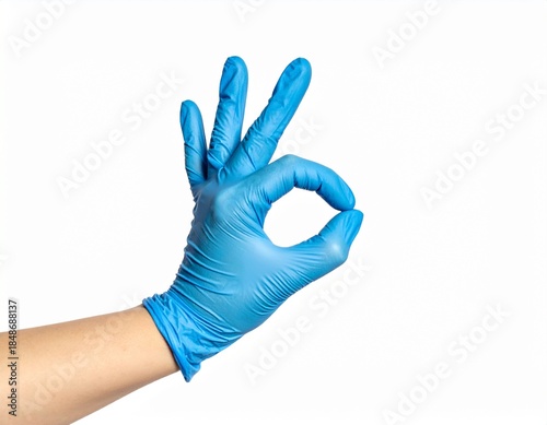 Blue gloved hand making the OK gesture against a clean white background, perfect for medical or health concepts.