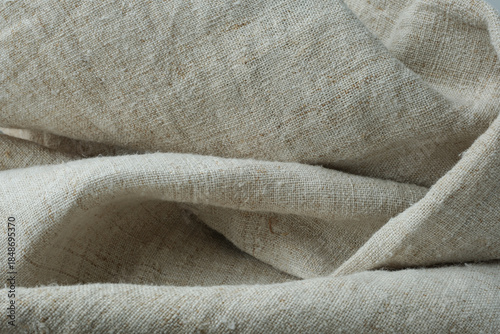 Folded hemp fabric. Rough, undyed hemp canvas. Selective focus.