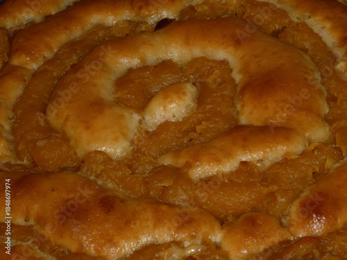 Homemade sweet pastry spiral with fruit filling close-up