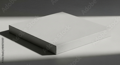 Minimalist light grey geometric cube pedestal with soft shadow, studio product display stage, abstract background for presentation
