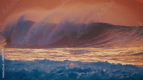 Hawaiian seascape. Ocean wave breaks on the Hawaiian shore of the Oahu island during sunset