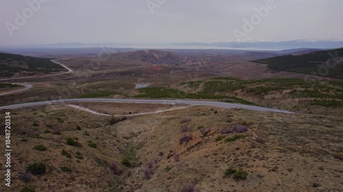 Aerial Drone View of Narrow Asphalt Road, Village and Beysehir Lake with Snowy Mountain