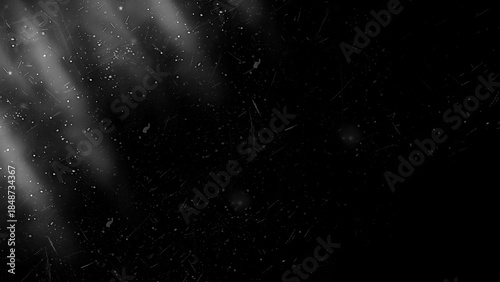 Black grunge texture overlay with light rays, scratches and dust for cinematic effect
