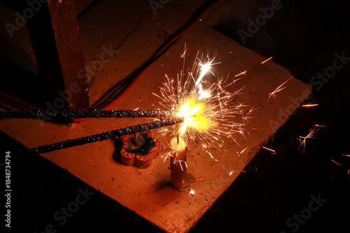Burning Sparkler Firecracker Producing Bright Sparks at Night
