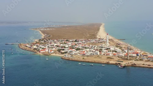 Ilha do Farol Faro lighthouse village turquoise sea drone view