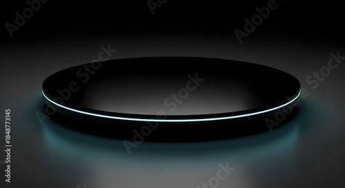 A sleek circular black platform with a subtle glowing blue ring around its edge presented in a dark studio setting