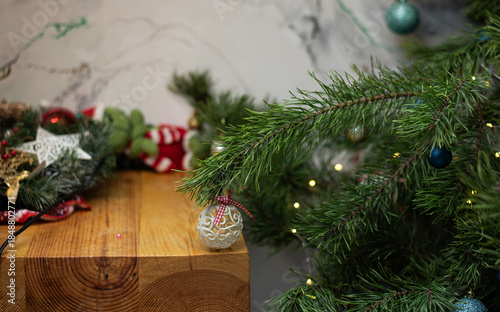 Cozy Christmas home interior with fir branches, ornaments and wooden table, festive holiday decor creating warm seasonal atmosphere