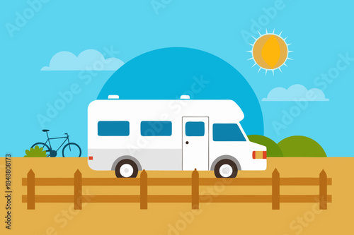 Vintage camper van parked by a wooden fence on a sunny day