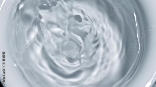 Close-up of water flowing into a container, creating ripples and swirling patterns. Pure liquid, clean