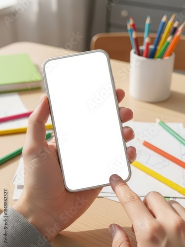 Hands Holding Smartphone at Desk with School Supplies for UI Mockup and Social Media Marketing