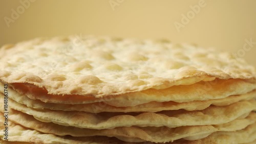 Stack of Baked Cake Layers Rotating: Close-up of crispy golden puff pastry crusts for traditional Napoleon cake or mille-feuille dessert