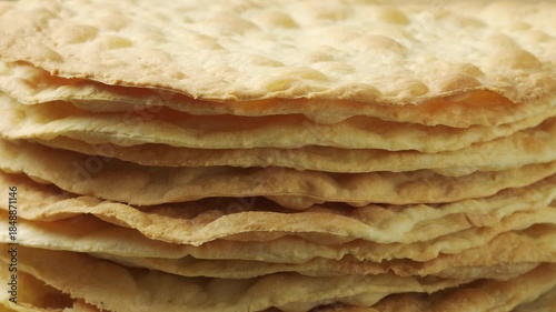 Stack of Baked Cake Layers Rotating: Close-up of crispy golden puff pastry crusts for traditional Napoleon cake or mille-feuille dessert