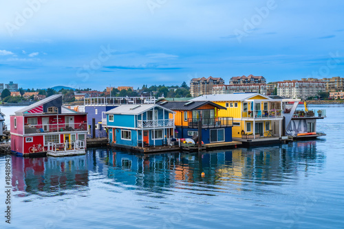 Photos Colorful floating homes reflecting in calm water in victoria, british columbia