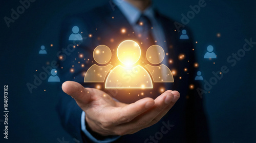 Concept of human resources, team, and network technology. Businessman holding glowing digital people icons in hand