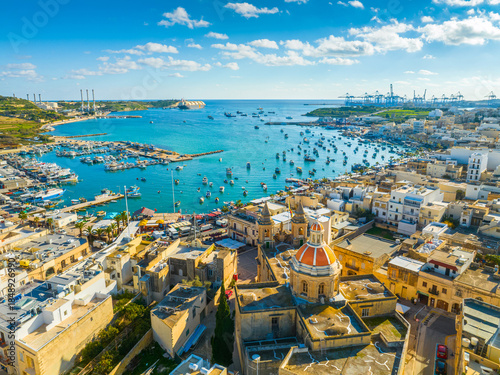Drone view of Marsaxlokk fishing village, Sunday market. Church dome. Malta island