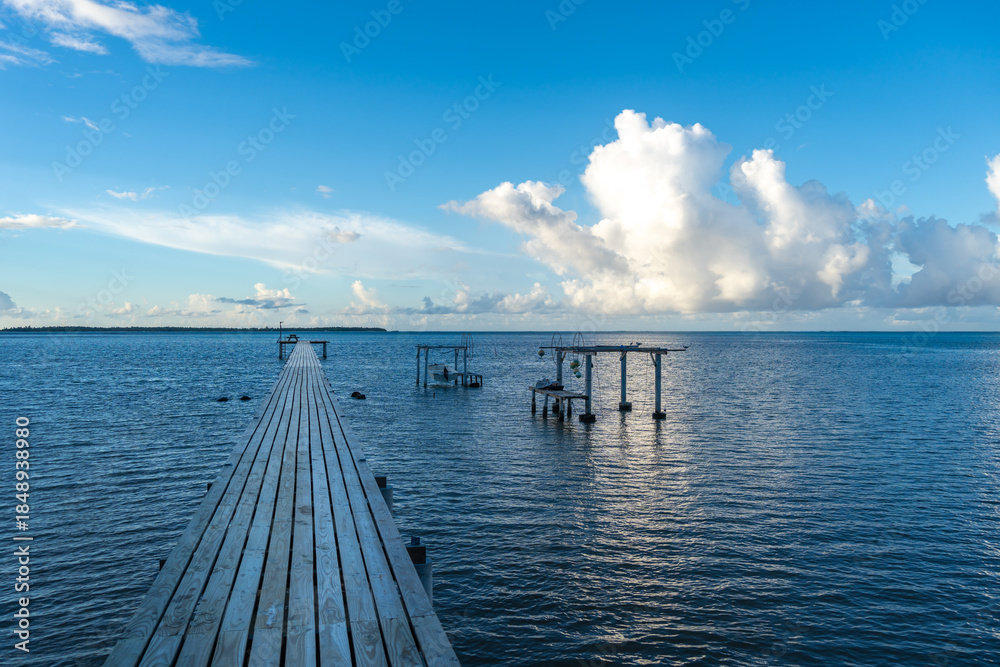 Fototapeta premium Sunset over the tranquil lagoon of Maupiti, French Polynesia