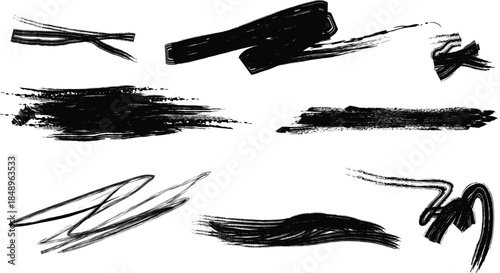Collection of black silhouette brush strokes on white background