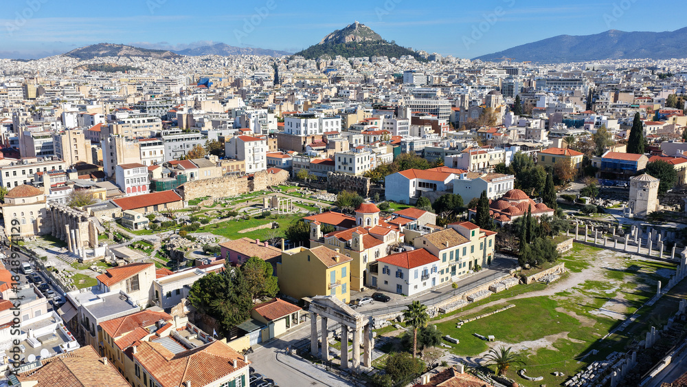 Obraz premium Aerial drone photo of iconic Roman Market featuring tower of Winds and Gate of Athena in the heart of Athens historic centre built in Plaka district, below Acropolis hill, Attica, Greece