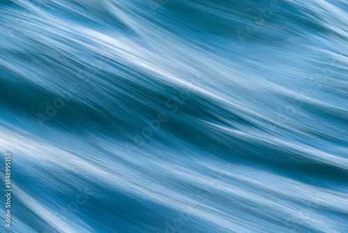 abstract blue background closeup of flowing, moving water