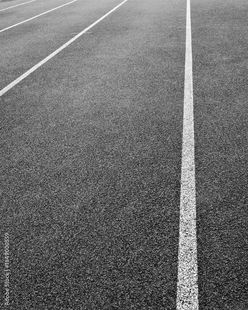 Fototapeta premium Empty running track with lane markings during early morning light in a quiet location