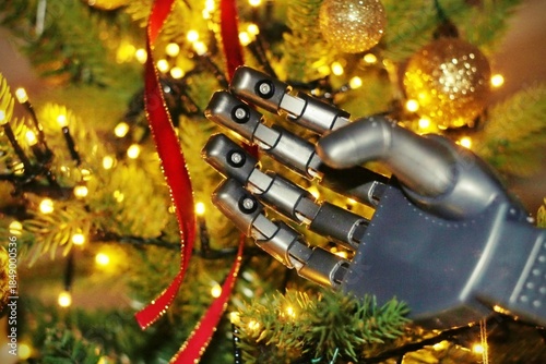 Futuristic Christmas tree with a humanoid robot hand holding a shiny and glitter futuristic black ornament with blue light and circuit print putting it on the Christmas tree.