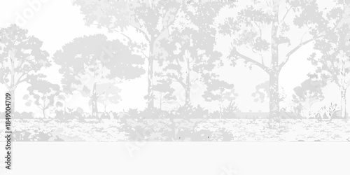 Silhouetted trees against a light gray sky create a serene landscape