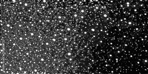 A dramatic black and white image depicting a field of scattered bright spots
