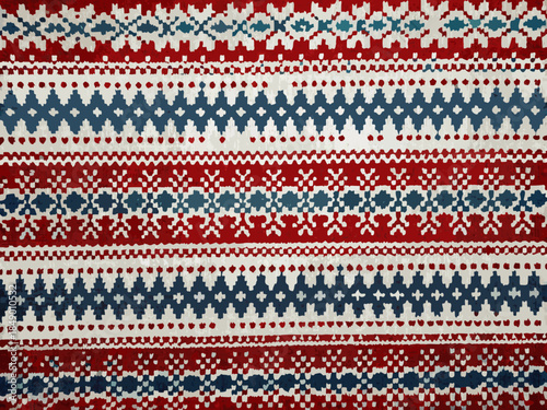 Close up of a knitted fabric displaying a colorful nordic pattern design