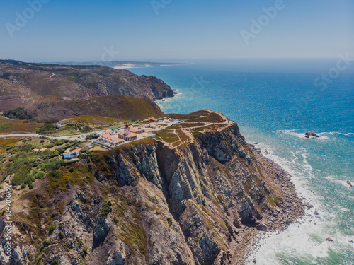 Aerial view of rugged cliffs meet the turquoise ocean at Cabo da Roca, Sintra, Portugal.